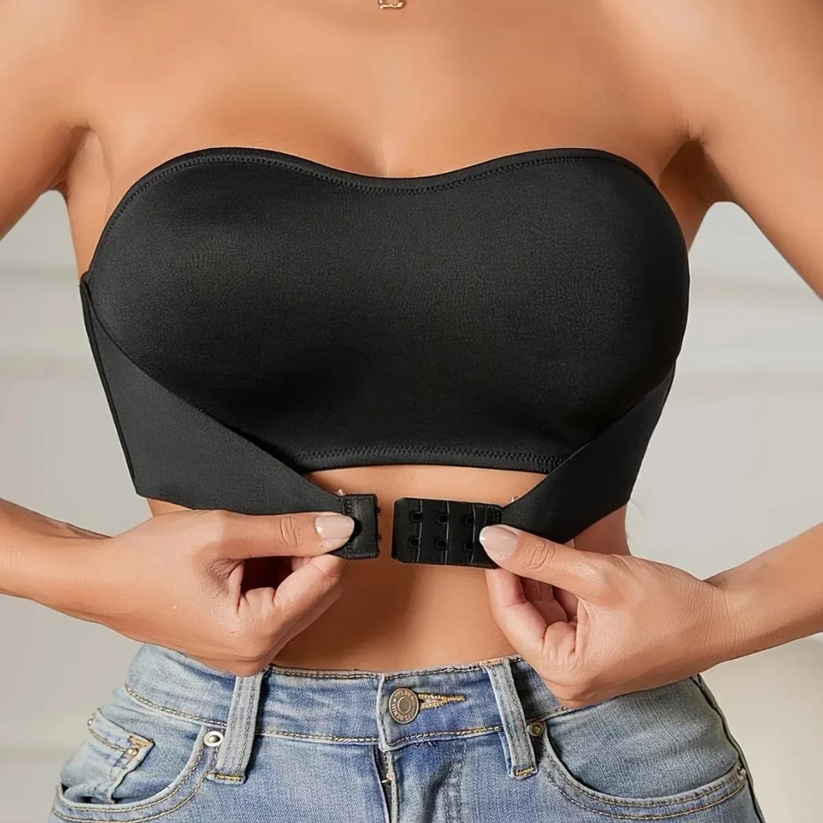 fastening the front hooks of the strapless push-up bra