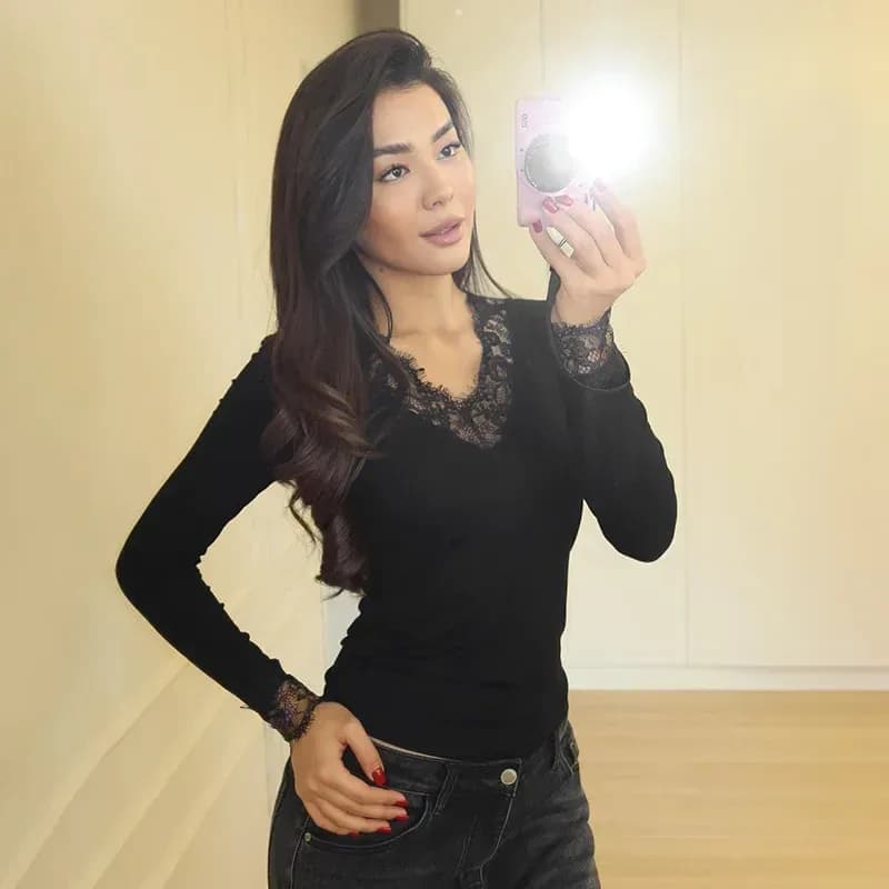 black lace trim V neck top worn with dark jeans